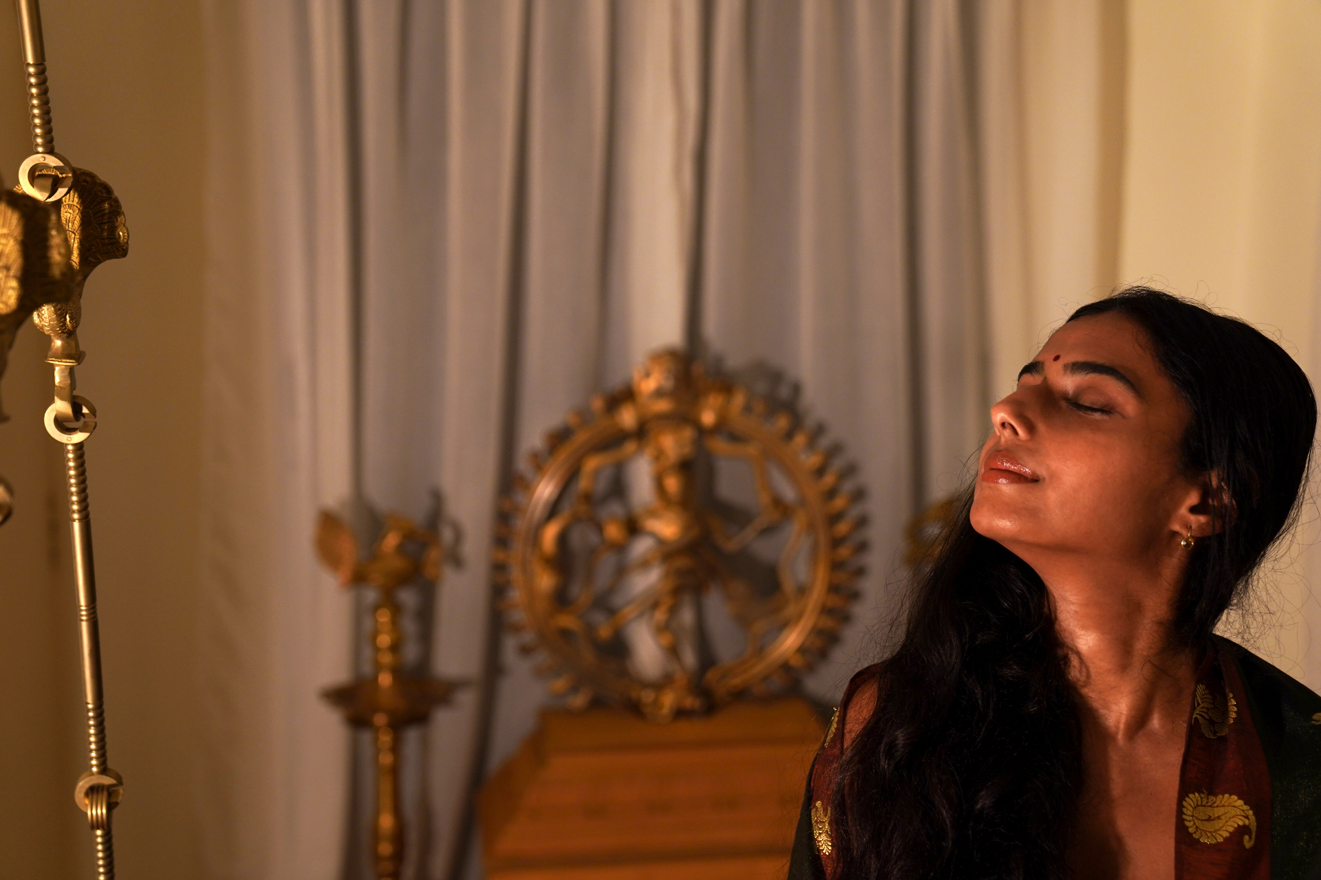 Shantrika in contemplation beside a bronze Nataraja