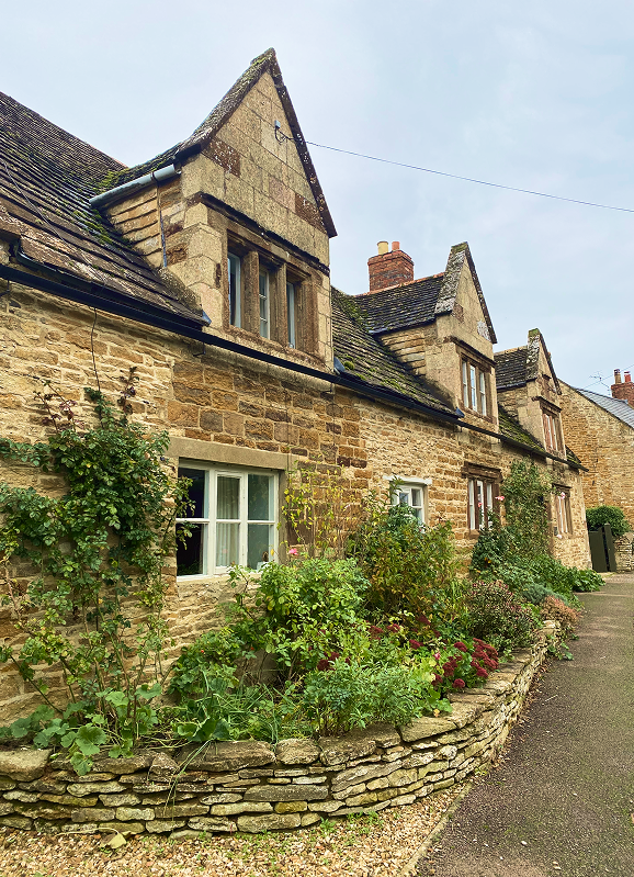 Honey-stone cottages along a Manton lane